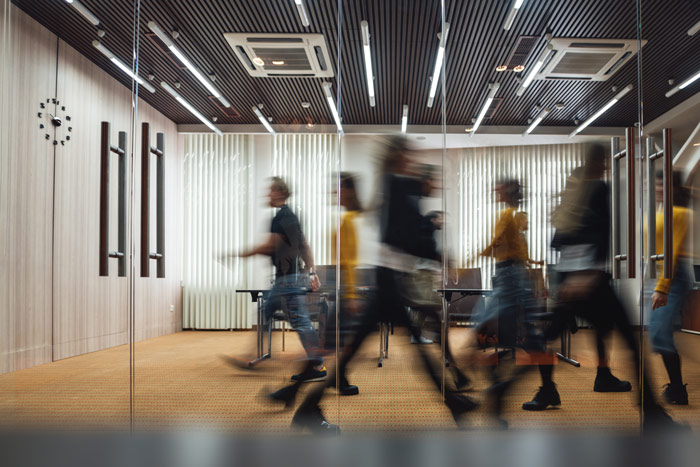 A busy office with people walking around