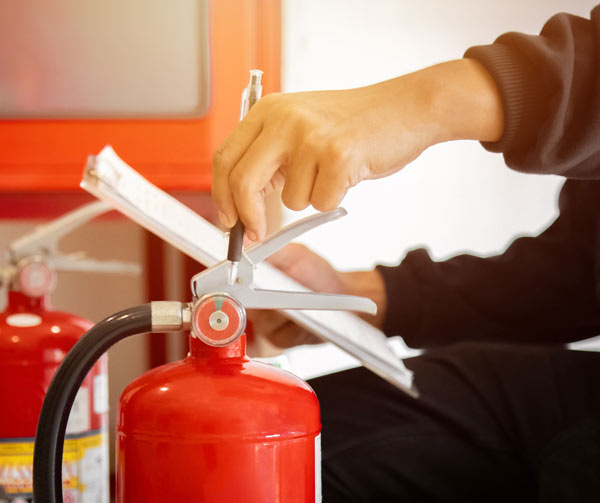 A fire safety assessor inspecting an Exeter commercial premises