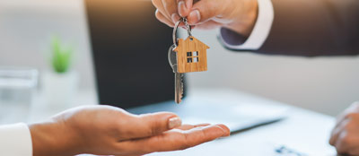 A landlord handing the keys to a tenant