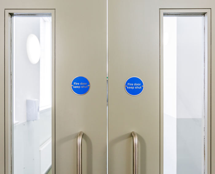 A close up of a double fire door
