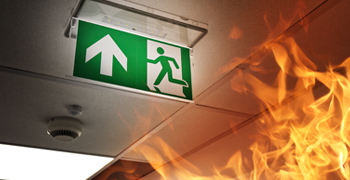 Fire Risk Assessments Bristol. Fire escape sign and impending fire.