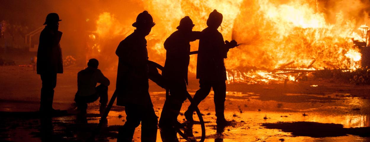Housing Fire Risk Assessments Bristol. Fire fighters trying to control a blaze.